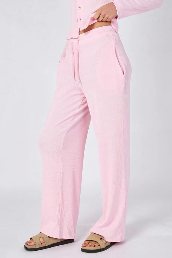 Person wearing pink pants on a white background