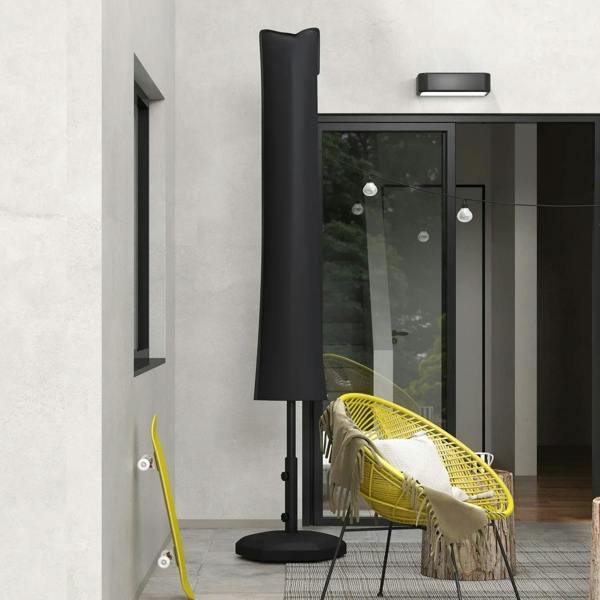 Black umbrella cover standing next to entrance on patio with umbrella base