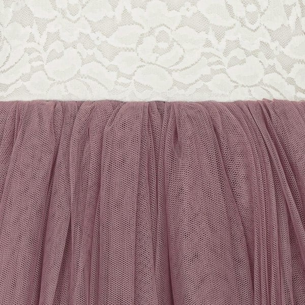 Close-up of a mauve tulle skirt with a lace background