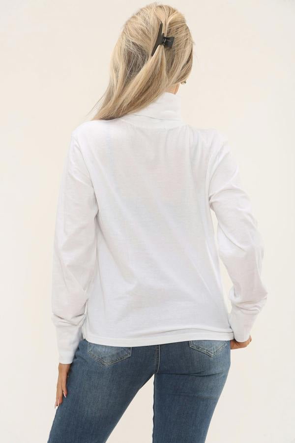Person wearing a white long-sleeve shirt and blue jeans on a beige background