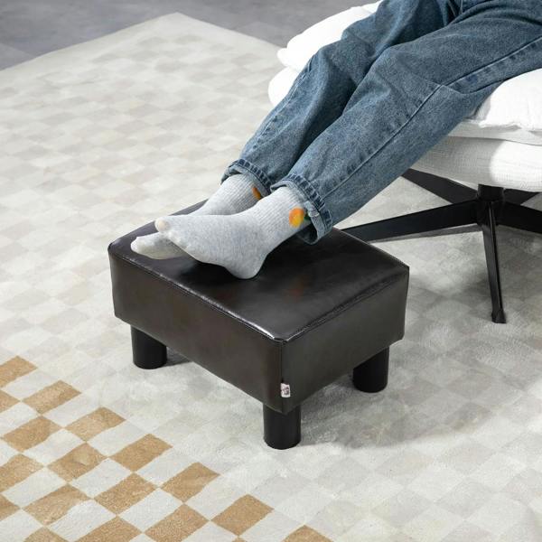 Dark PU leather cube ottoman with cushioned square seat and four black plastic legs.