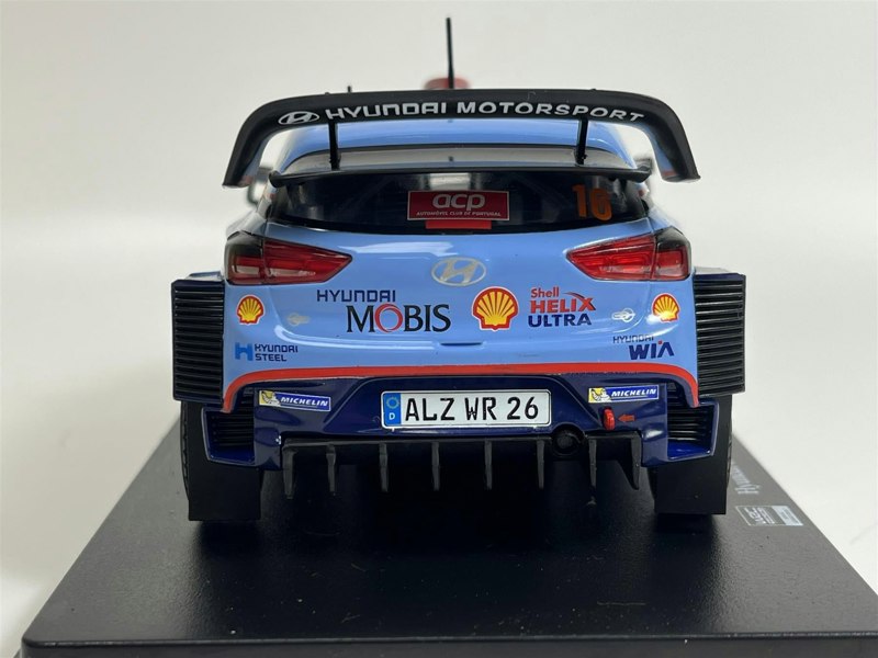 a blue race car on a black surface