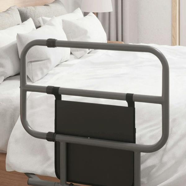 Black folding bed rail positioned over white bedding with front storage pocket panel.