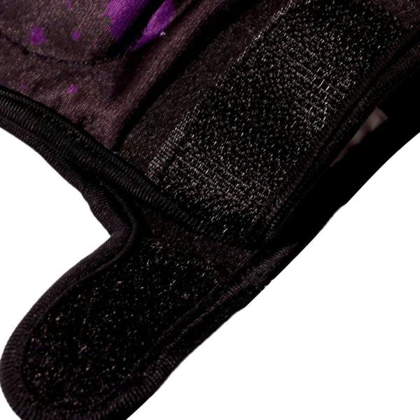 Close-up of black Optimum Fusion hockey glove Velcro cuff with purple splatter print, on white - Optimum