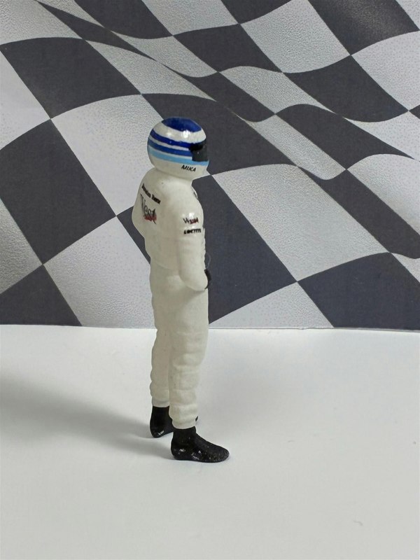 a toy figure in a white suit
