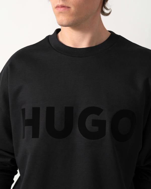 close up shot of a model wearing a HUGO Dinex Mens Oversized-Fit Sweatshirt in Cotton Terry with Tonal Logo in Black 001
