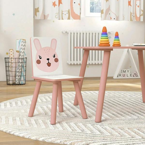 Close view of pink kids chair and small table with animal face panel and toy stack