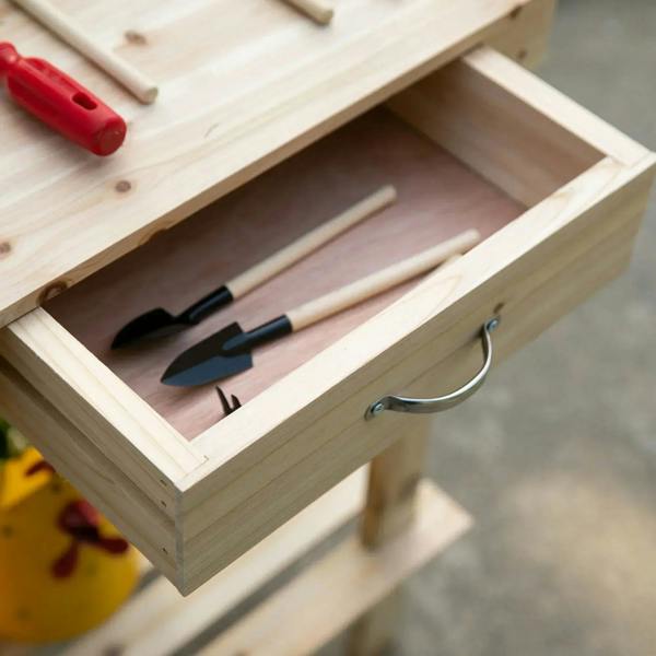 Wood potting bench drawer storage with gardening tools neatly arranged inside
