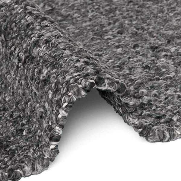 Close-up of textured gray carpet roll on a white background
