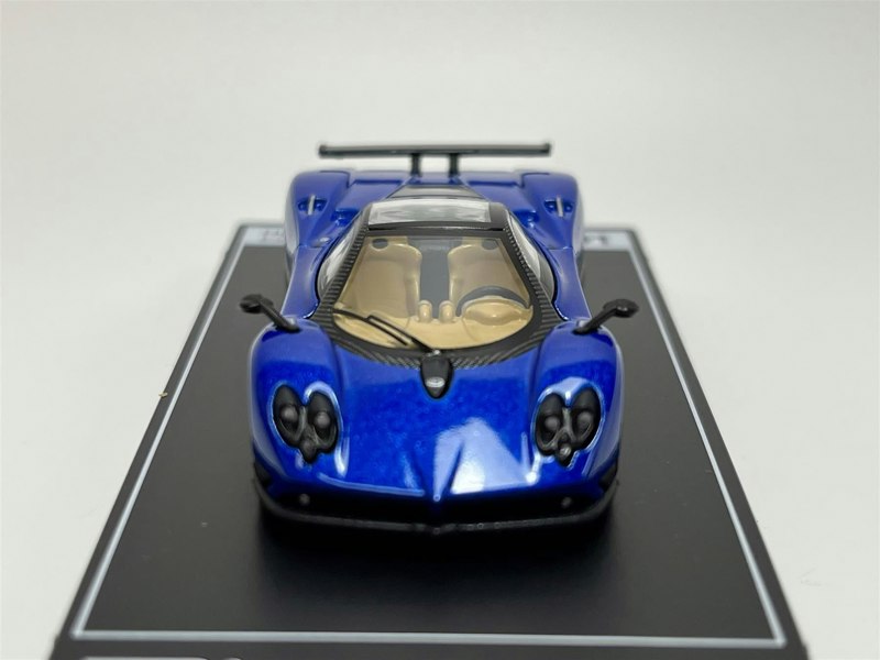 a blue toy car on a black surface