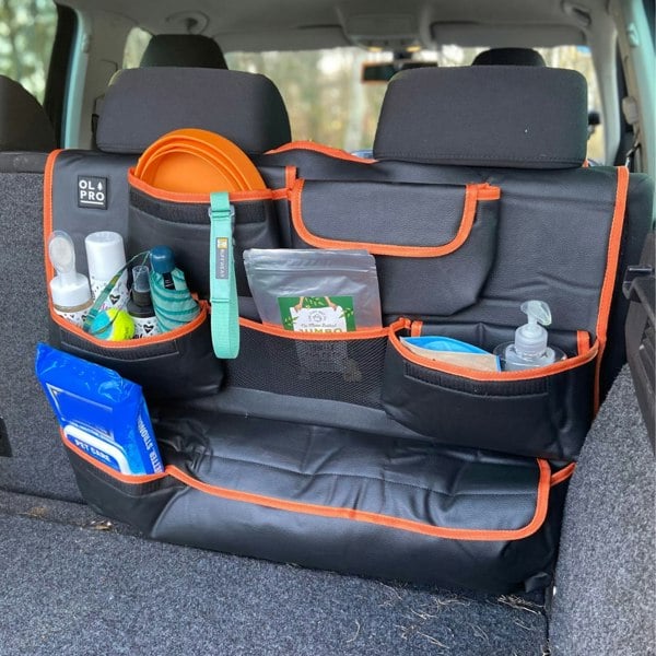 The OLPRO Rear Double Seat Storage Organiser in orange that is full of dog walking items and attached to the back of the rear seats of a VW vehicle.