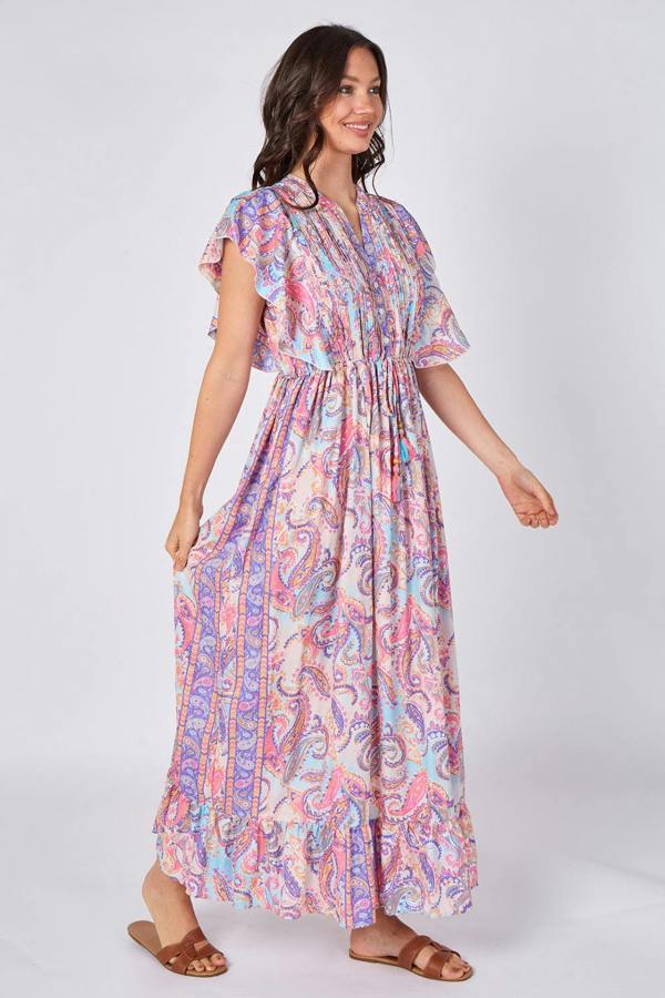 Woman wearing a colorful patterned dress on a white background