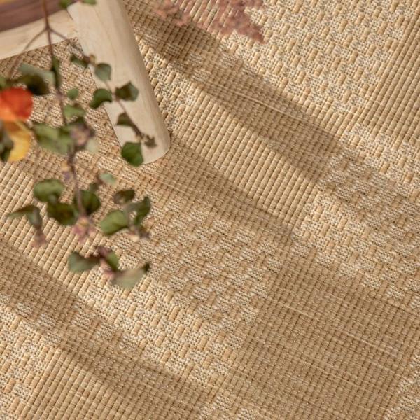 Textured beige fabric with a vase and floral arrangement on a wooden surface