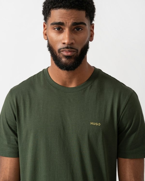 close up of a model wearing a HUGO Dero222 Mens Cotton-Jersey T-Shirt with Logo Print in Dark Green