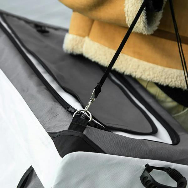 Grey padded pet stroller seat with safety tether clip and mesh base