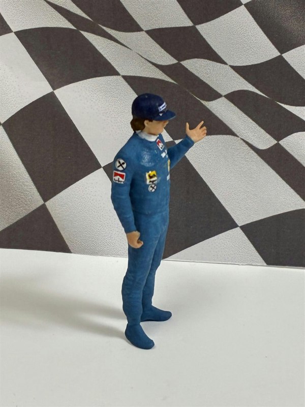 a toy figure of a man in a blue uniform