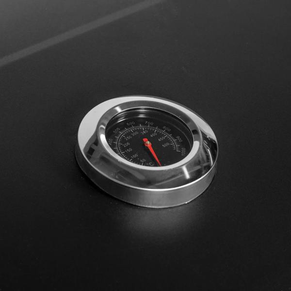 Close-up of black grill lid thermometer with temperature gauge