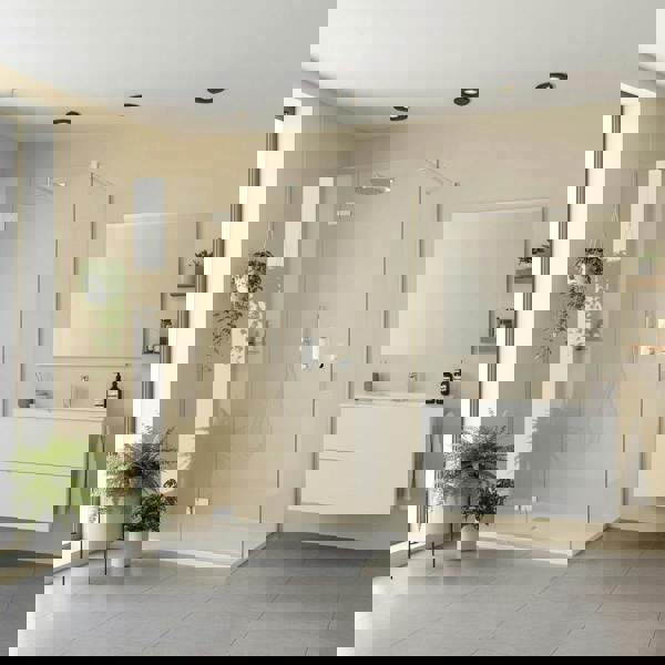 Mini recessed spot lamp above a shower and sink in a modern bathroom with plants and toiletries