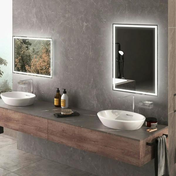 LED bathroom mirror with illuminated border above a vanity sink