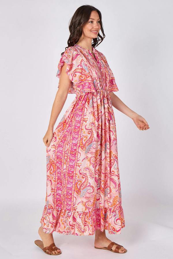 Woman wearing a pink and orange patterned dress on a white background