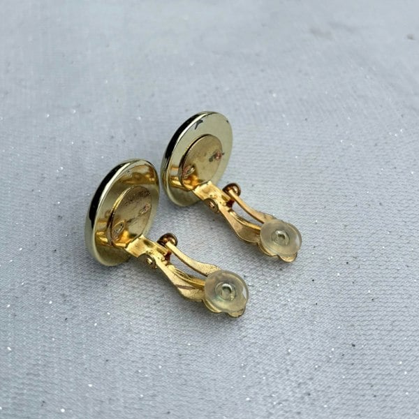 Red and gold clip-on earrings, round dome design, glossy red centre, gold-tone border, bold statement jewellery, vintage-inspired accessory
