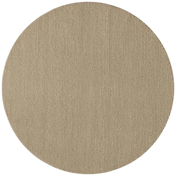 Round beige rug with a textured pattern on a white background