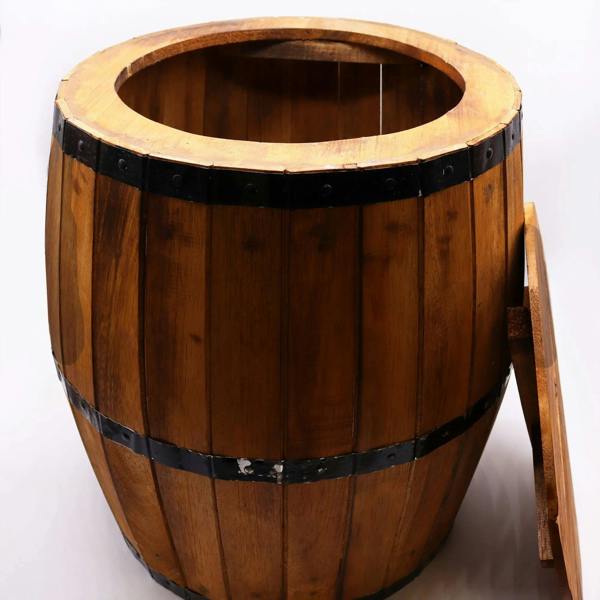 Natural wood barrel table with round opening on top and dark metal bands