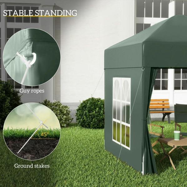 Green pop-up gazebo with white window panel and visible guy ropes and ground stakes