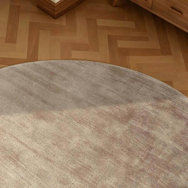 Round brown rug on a wooden floor