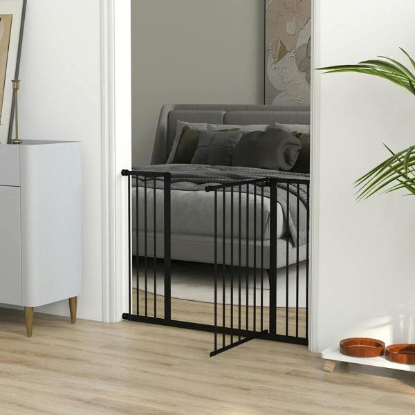 Black pet safety gate installed near a sofa with vertical bars