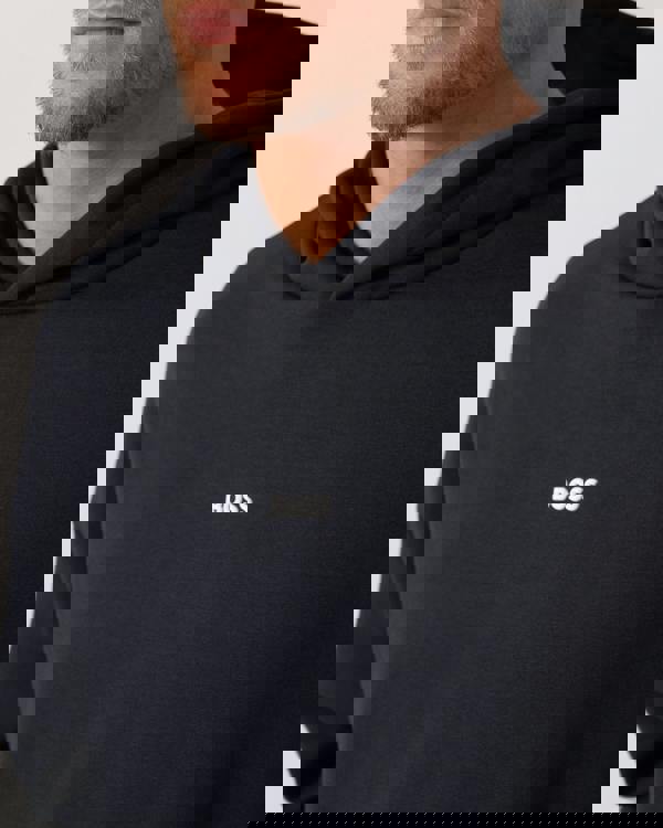 Model wearing BOSS Green Sly Zone Mens Pullover Hoodie in Dark Blue 403 - Logo detail