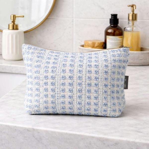 Indigo jacquard zip toiletry bag standing upright on countertop