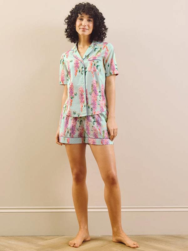 model wears wisteria print short pyjama set. 