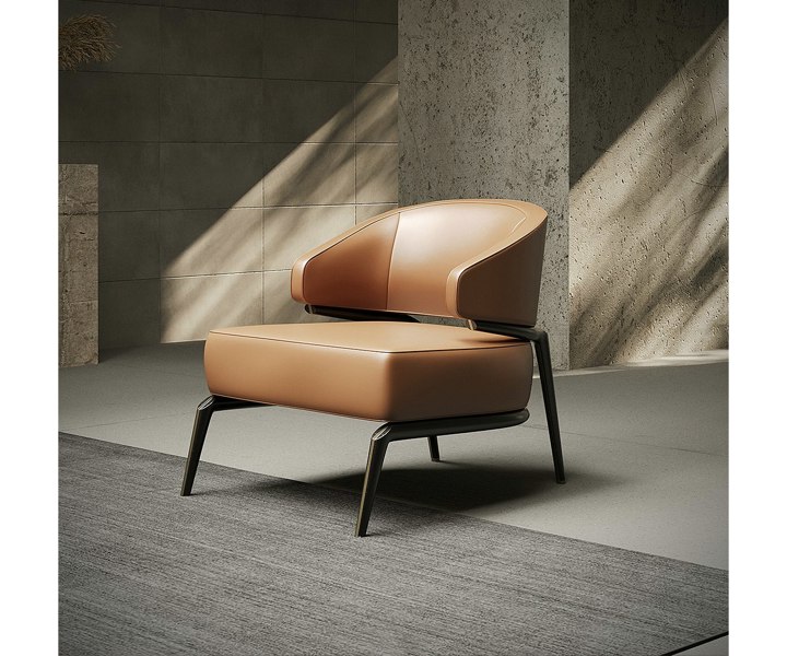 A modern armchair with a curved leather seat and backrest, supported by a sleek metal frame. The armchair is placed on a grey rug in a minimalist room with concrete walls and natural light.