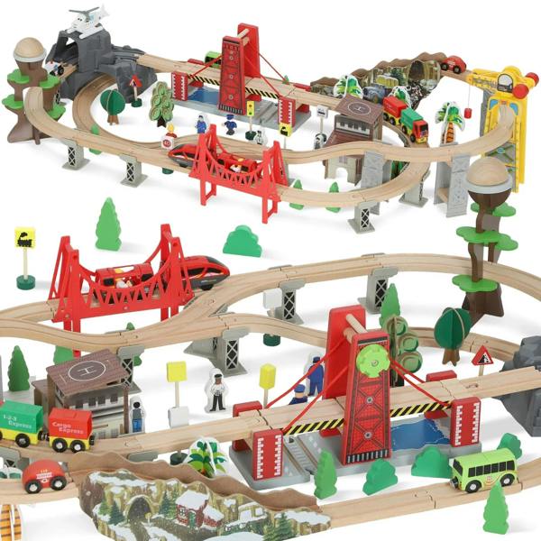 Wooden train set with battery train, track, red crane bridge, and green trees