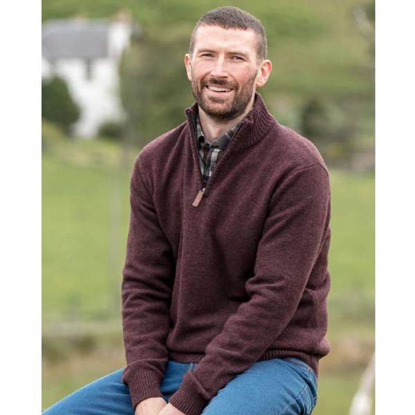 Man with beard wearing the Hoggs of Fife Lothian II 1/4 zip pullover with countryside background