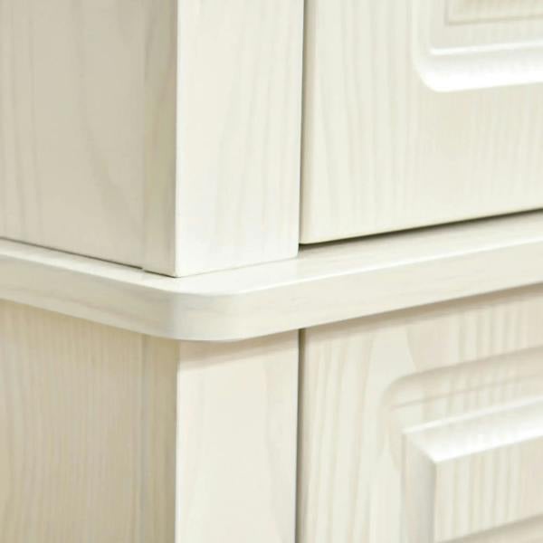 White cabinet corner with decorative paneling and black round handle