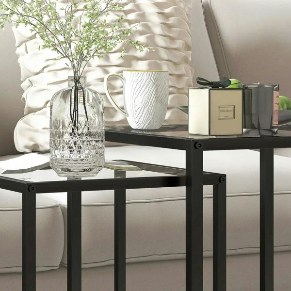 Black side table with clear tempered glass top and open steel frame, nesting design
