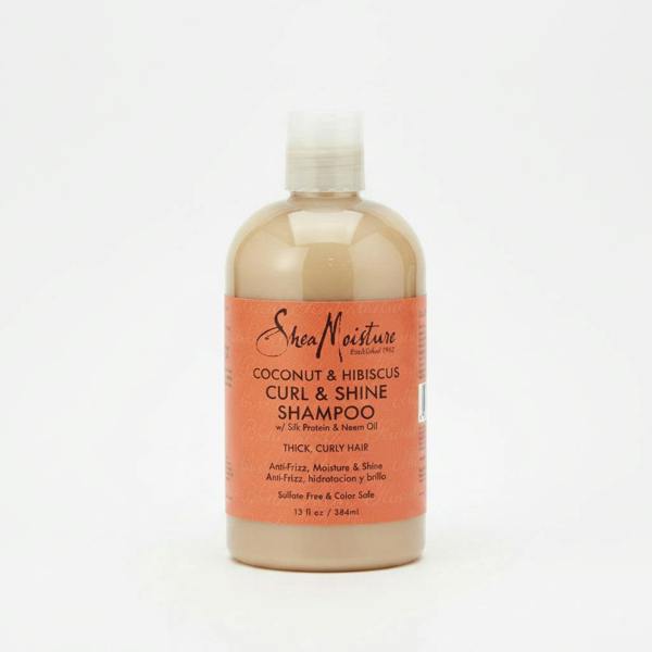 A bottle of Shea Moisture Coconut & Hibiscus Curl & Shine Shampoo, 384ml, with a beige label on a white background.
