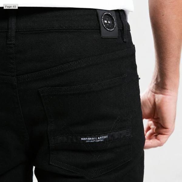 Marshall Artist black overdye denim jeans featuring a branded back patch and rear pocket logo detail.
