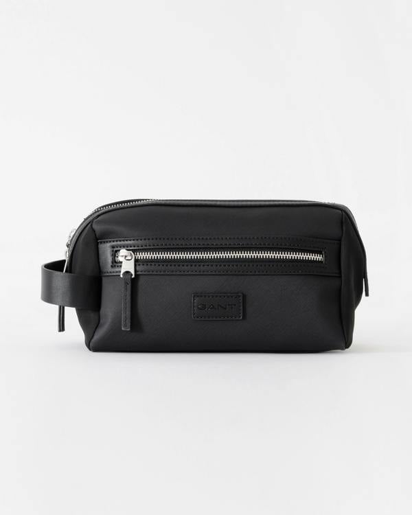 Black toiletry bag with silver zipper on a white background