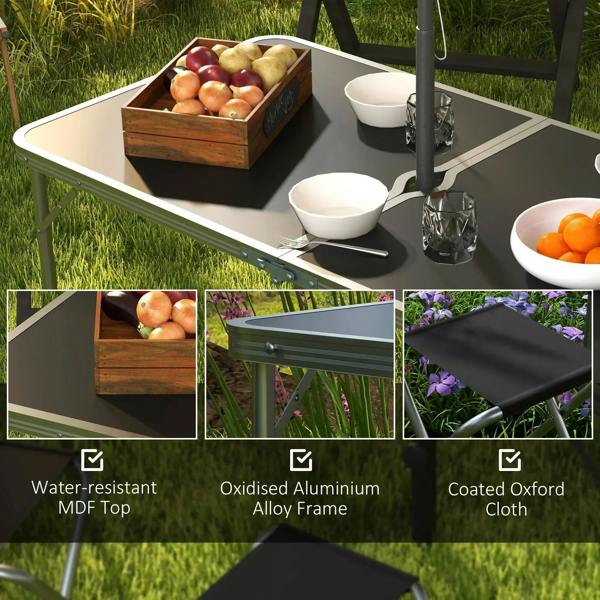 Black foldable picnic table with foldable stools and serving bowls on top