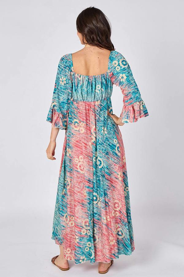 Woman wearing a colorful patterned dress on a white background