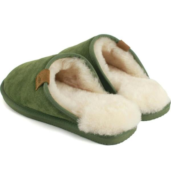 A pair of men's slip-on slipper mules featuring a rich olive green suede upper, an overflowing plush natural cream sheepskin lining, a small tan pull tab, and matching olive soles on a plain white background.