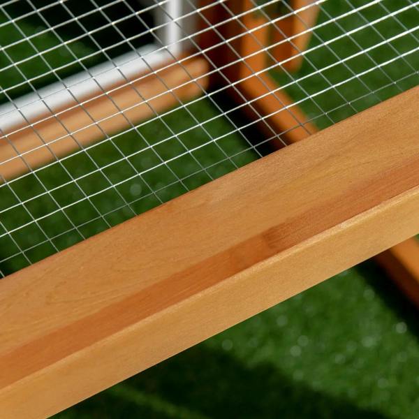 Close-up of wooden rail and wire mesh grid on the chicken coop run