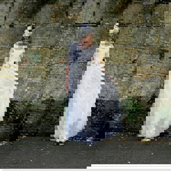 Girls looking at floor wearing dress