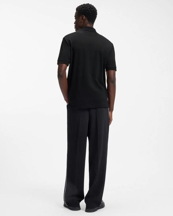 Model wearing HUGO Dalomino Mens Short Sleeve Zip Placket Polo Shirt with Contrast Logo in Black 002 - Back