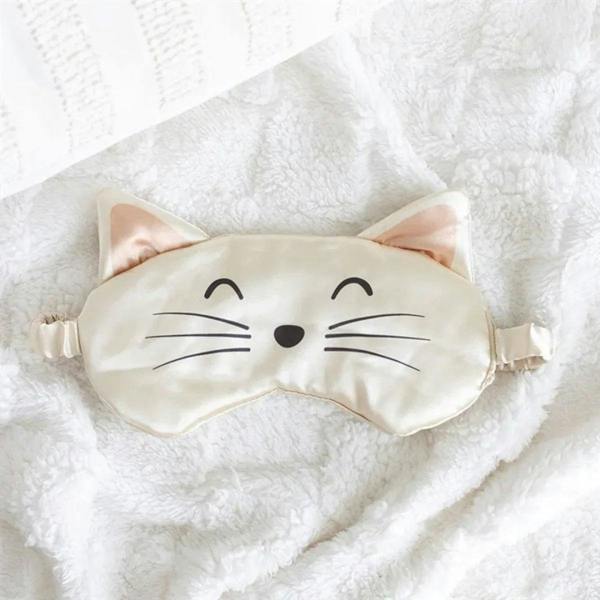Cream cat-face satin eye mask with bow-shaped ears and whisker face
