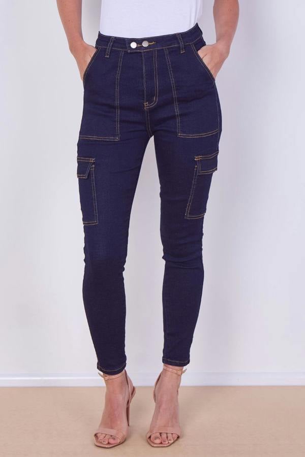 Navy blue jeans worn by a person on a white background
