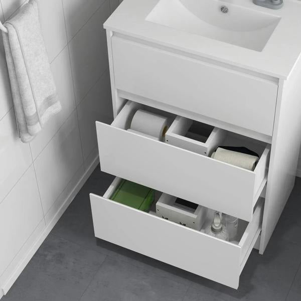 Bathroom vanity unit with two open pull-out drawers showing storage compartments